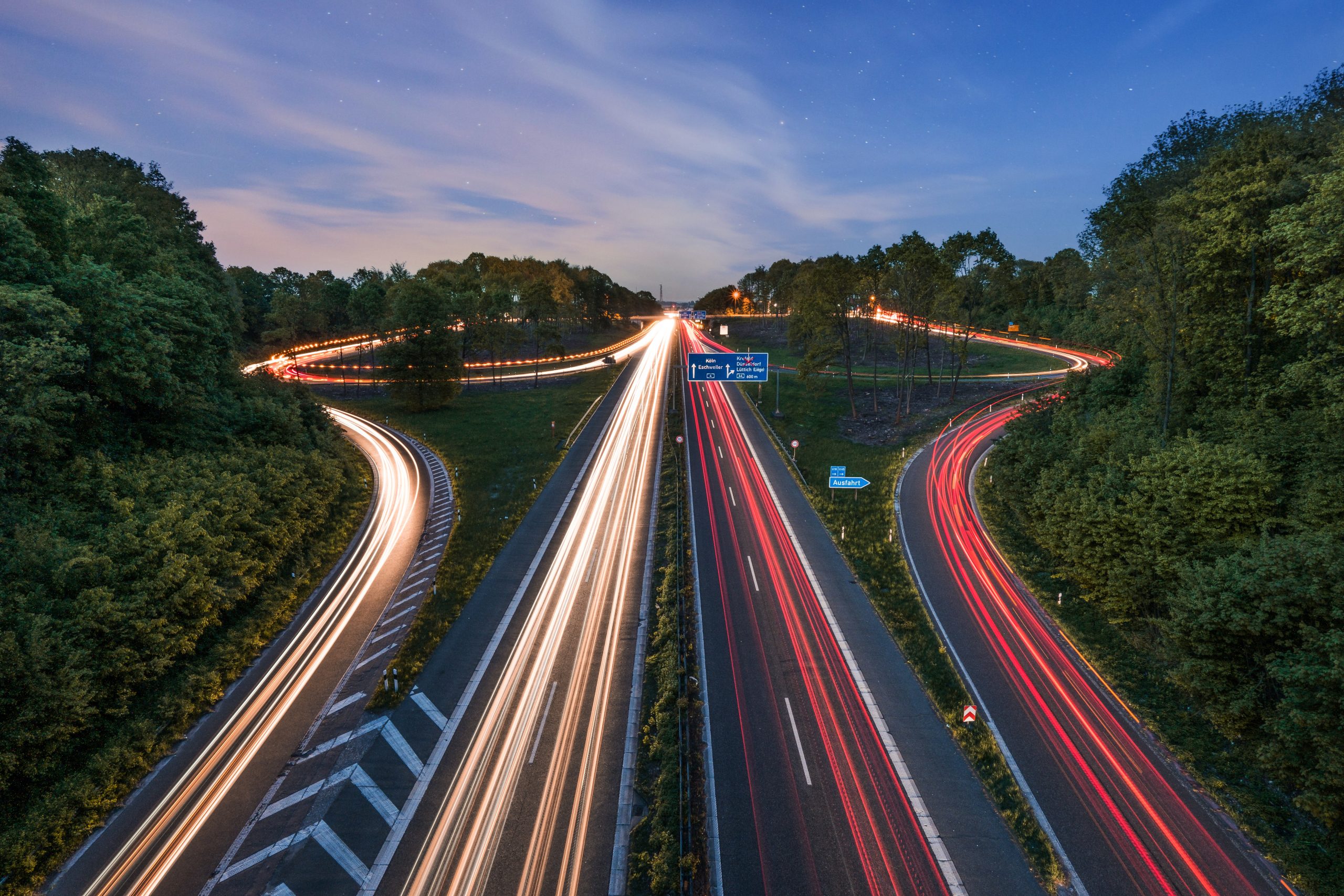 Building material haulage - New motorways with car headlight and brake light streaks